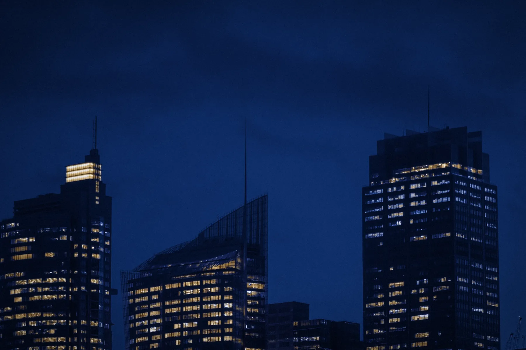 A city at blue hour, seen from a high office